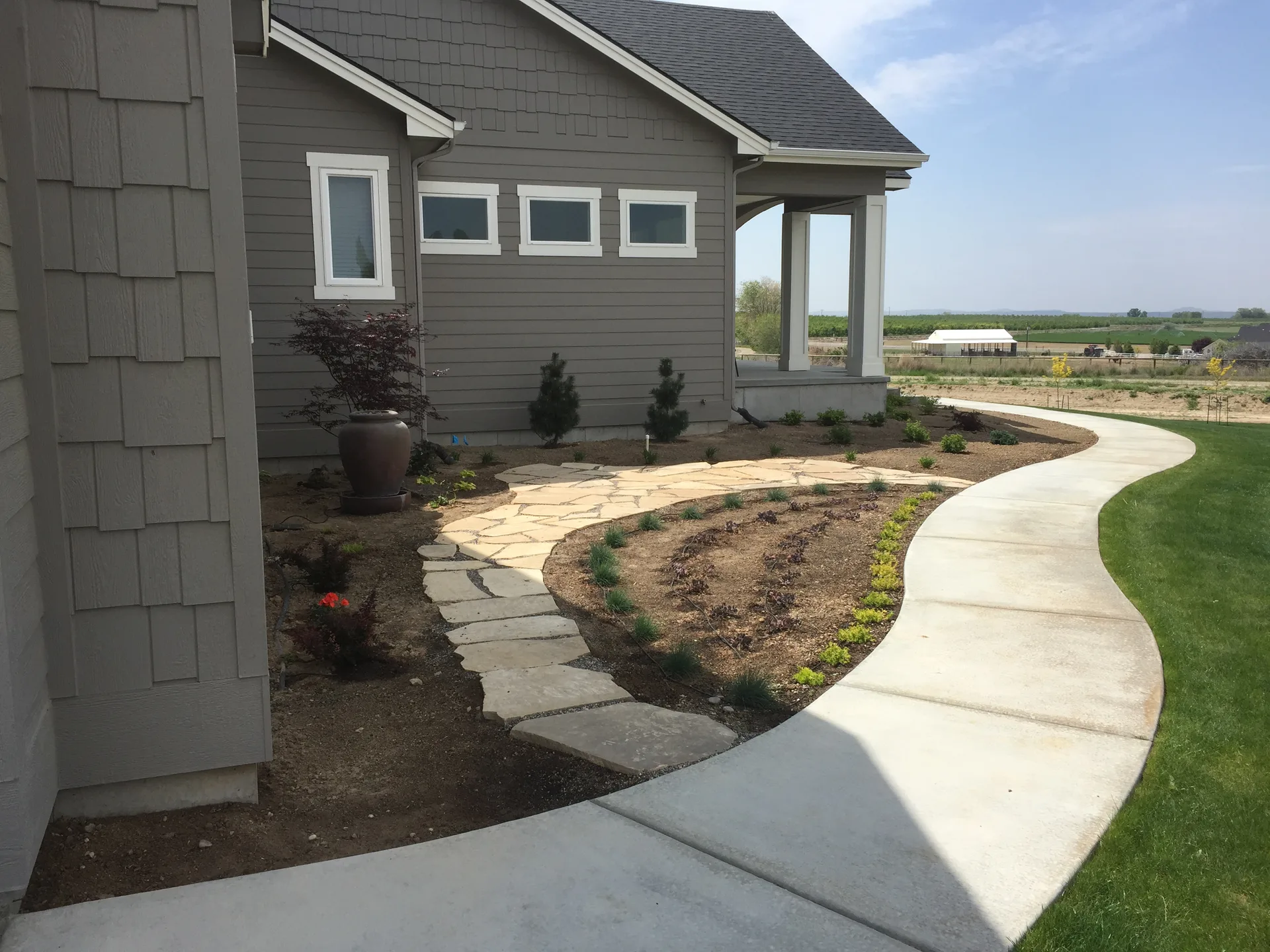 Finished landscaping and stonework detail on a Timberline Building Company home